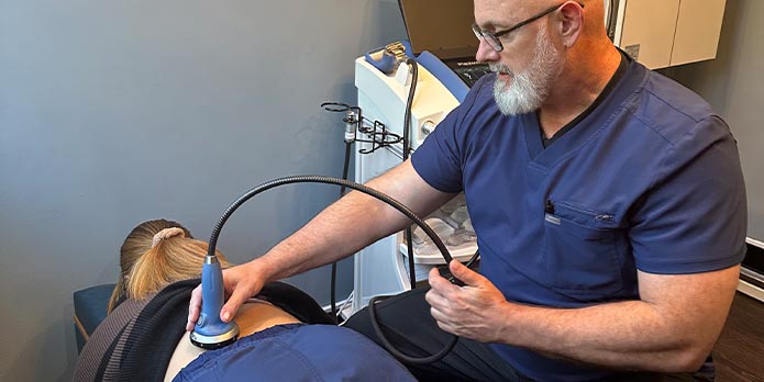 patient getting shockwave therapy as an auto accident injury treatment in Raleigh